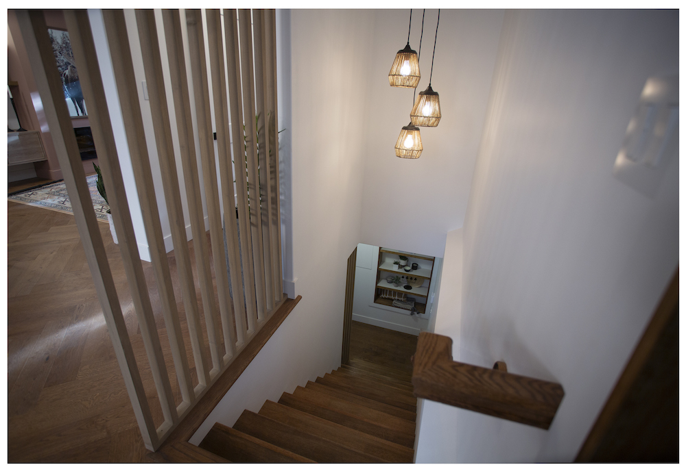 wood staircase with wood floor-to-ceiling spindle details