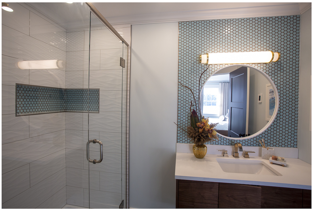 coastal bathroom with blue tile and white walk-in shower