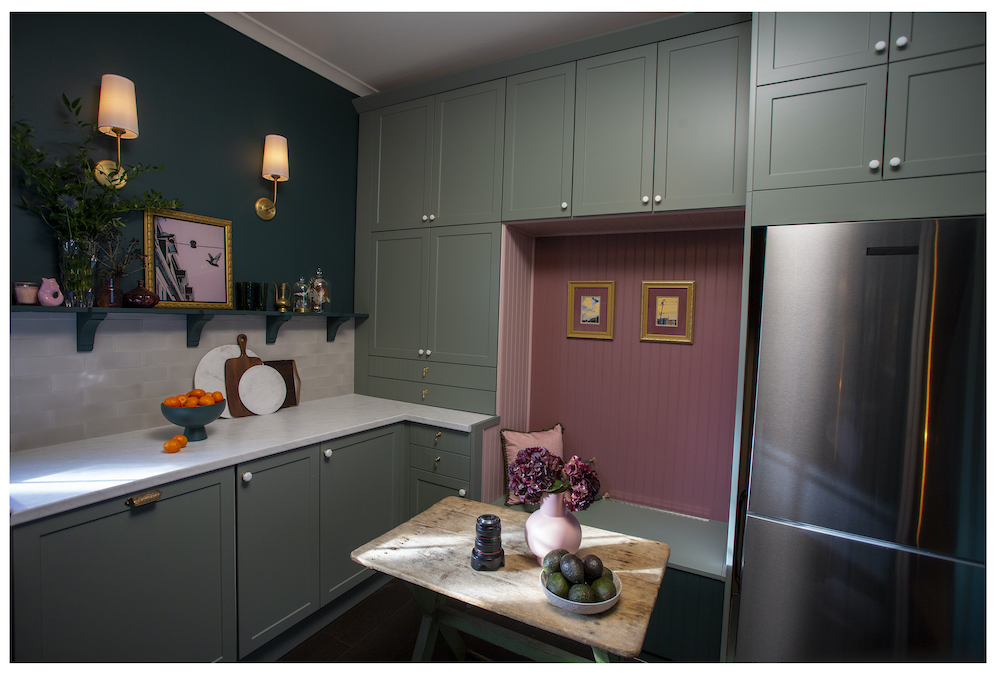kitchen with sage-green cabinets and mauve bench seat
