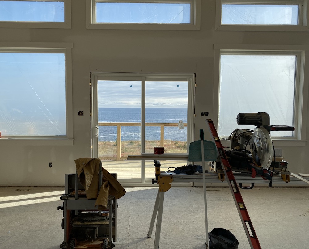 house under construction, with views of the Atlantic Ocean in background through windows
