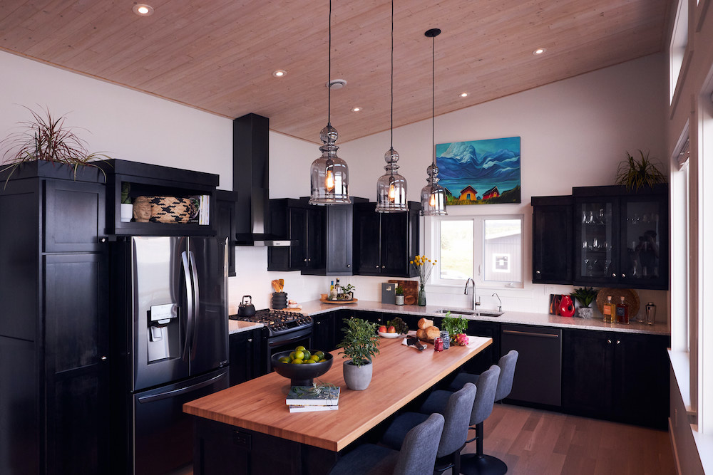 kitchen with high ceilings, dark cabinets and wood centre island