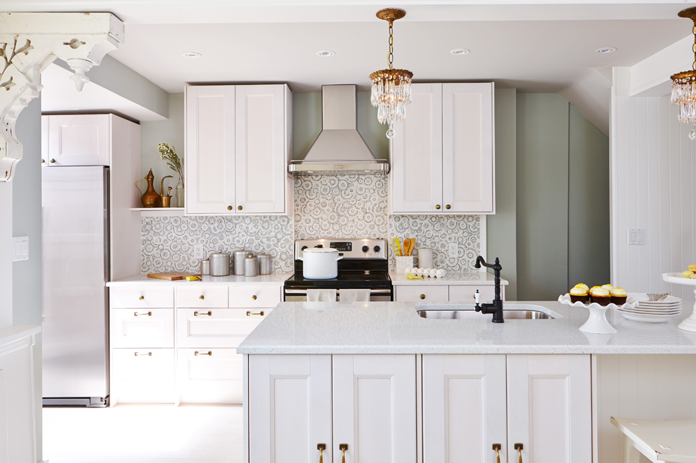 All-white kitchen with unique swirled backsplash.