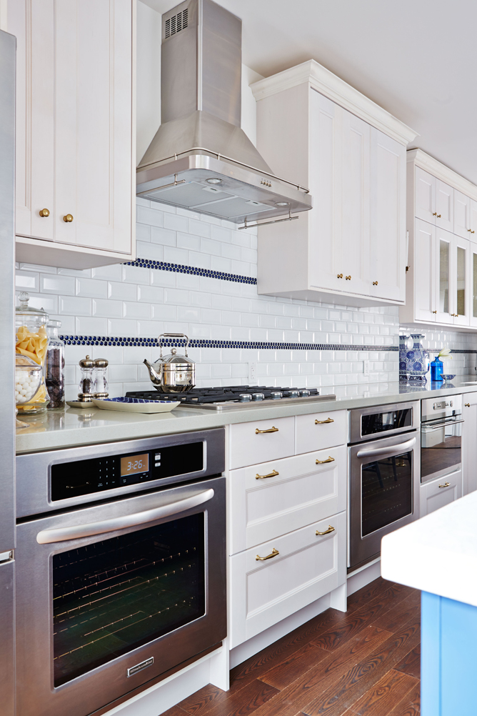 Modern blue, white and gold kitchen.