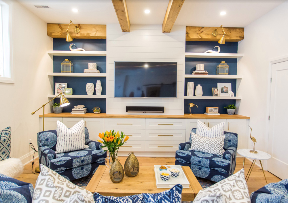 Basement with blue and white furniture and wood coffee table