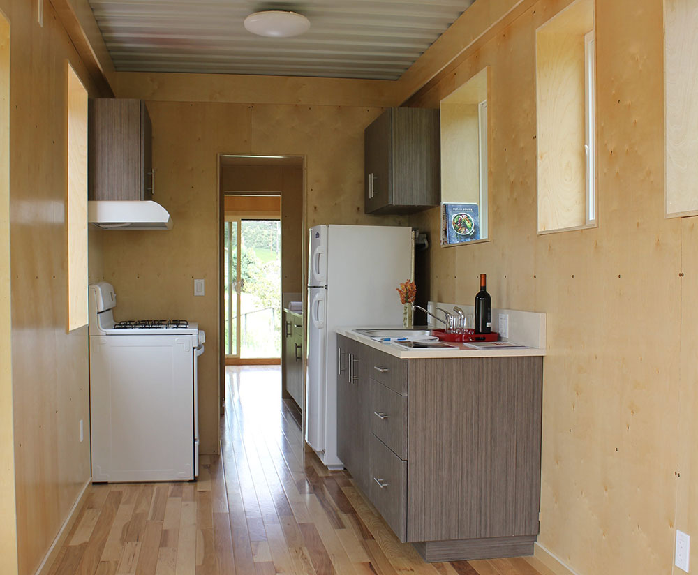 Sparse interior of a container home with hardwood flooring