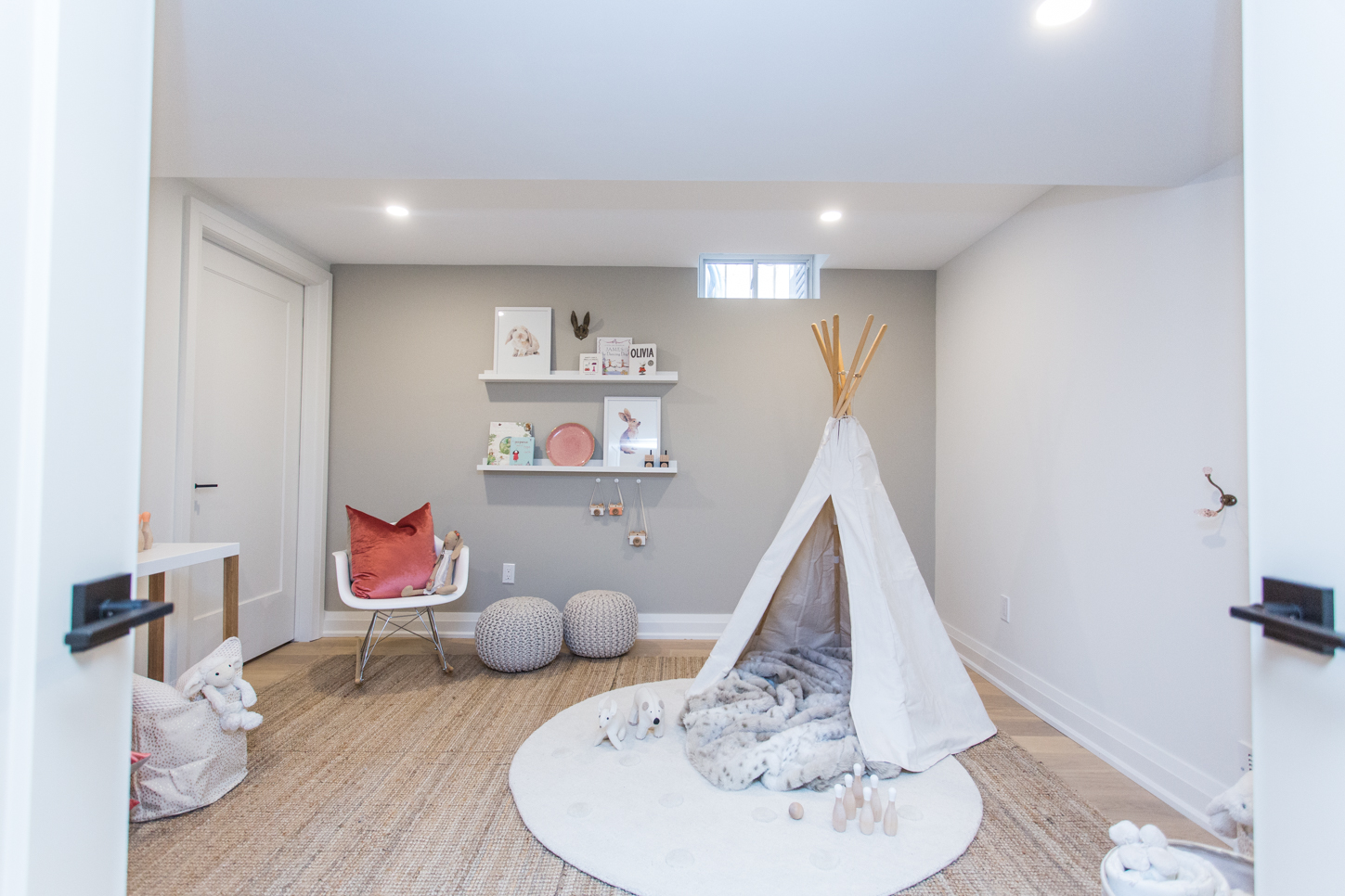 Kid's play room with a white teepee, carpet and white circle rug