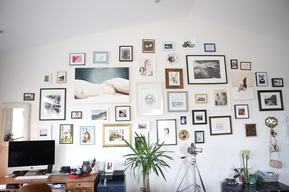 gallery wall with computer in left corner