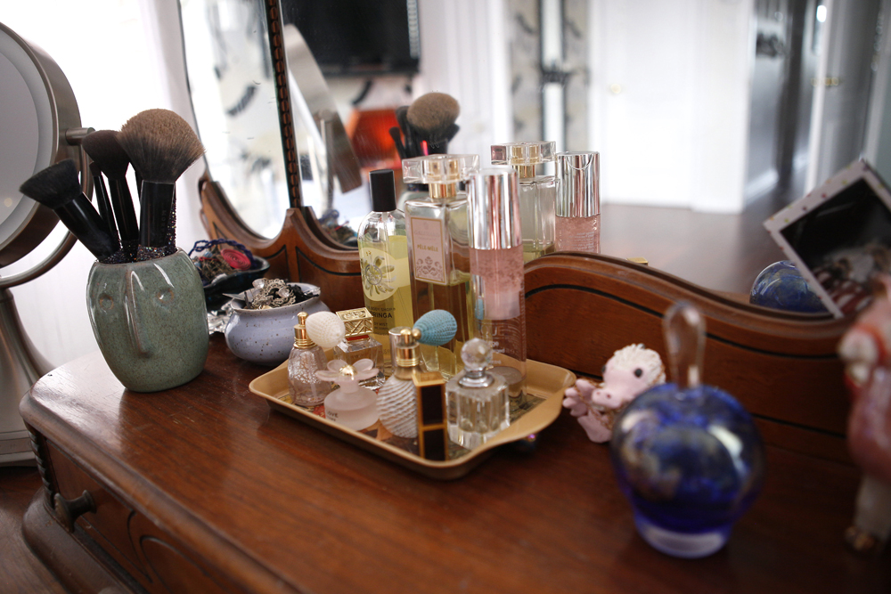 perfume bottles on tray on dresser