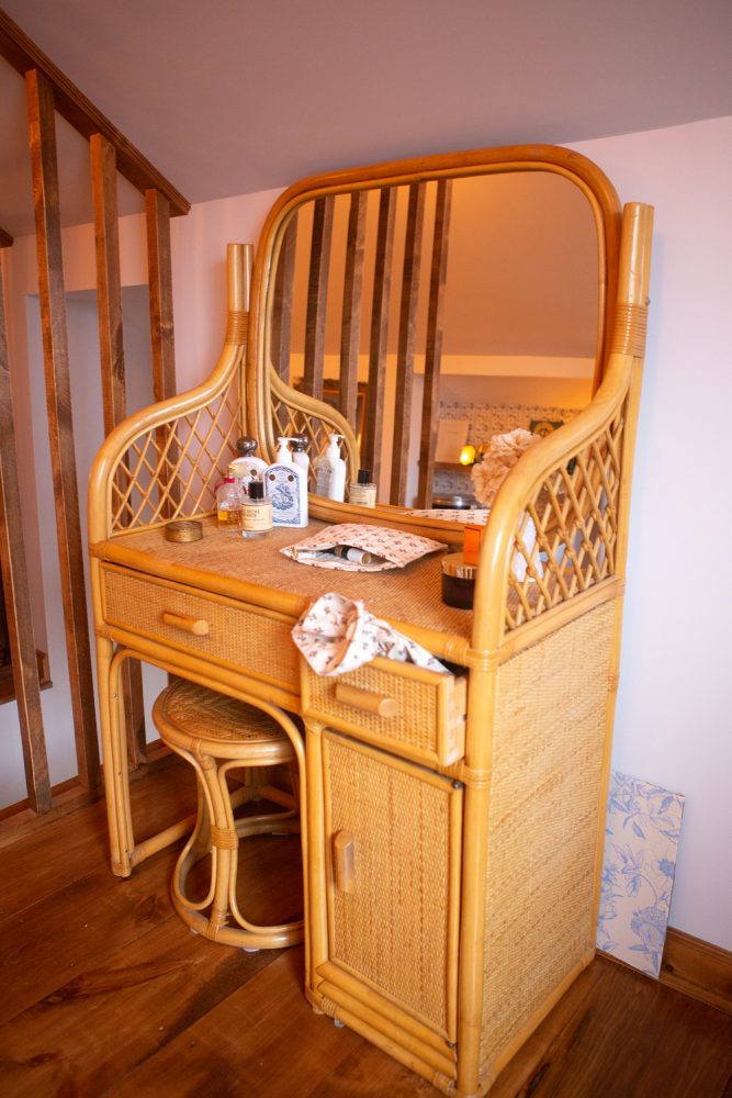wicker vanity and matching chair in bedroom