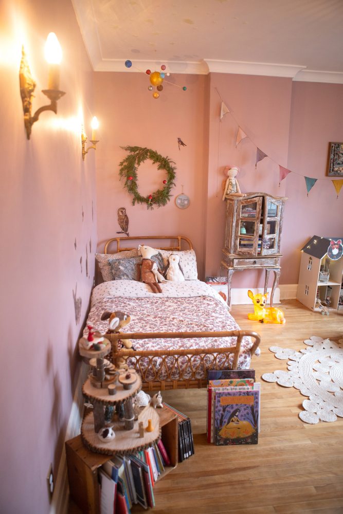 pink bedroom with wicker bed