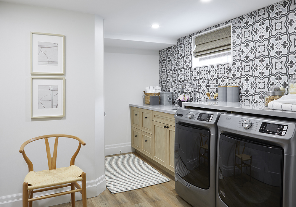 A laundry room with decorative tiles