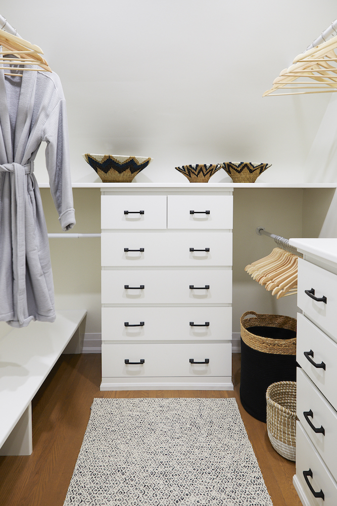 white walk-in closet with drawers, shelves and baskets