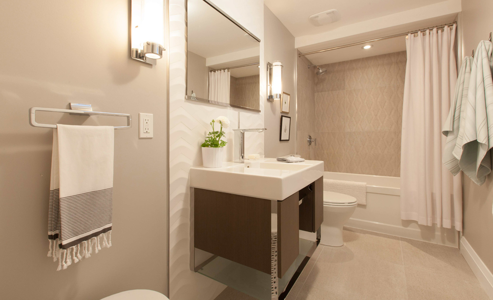 A four piece bathroom featured in a basement apartment.