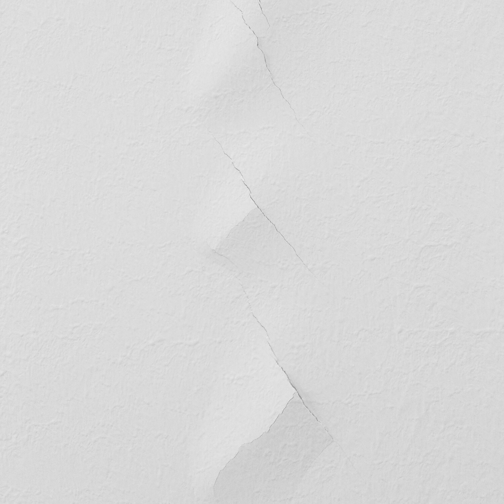 A white wall with a crack going down the middle.