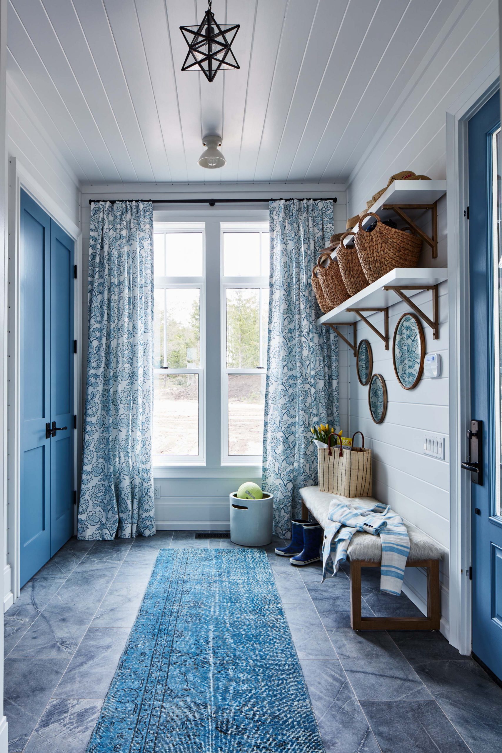 Soft blues distinguish this mud room with its elongated bench and easily washed tiles.