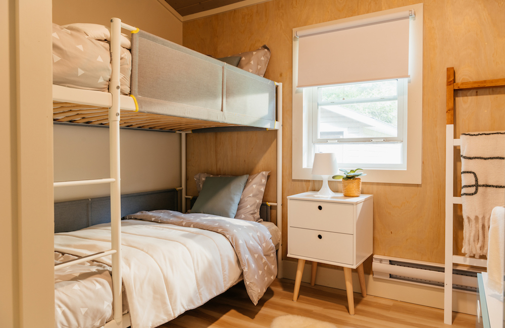 A bunk bed in a bedroom with a beige colour scheme.