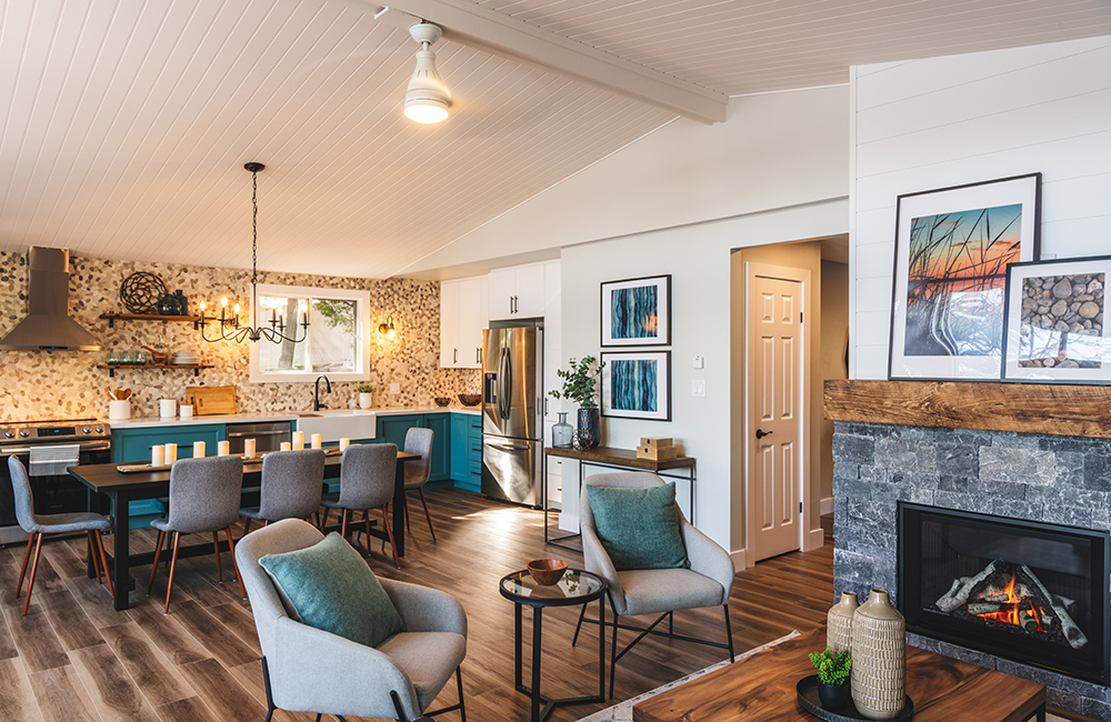 An open concept cottage space with painted paneling on the ceiling.