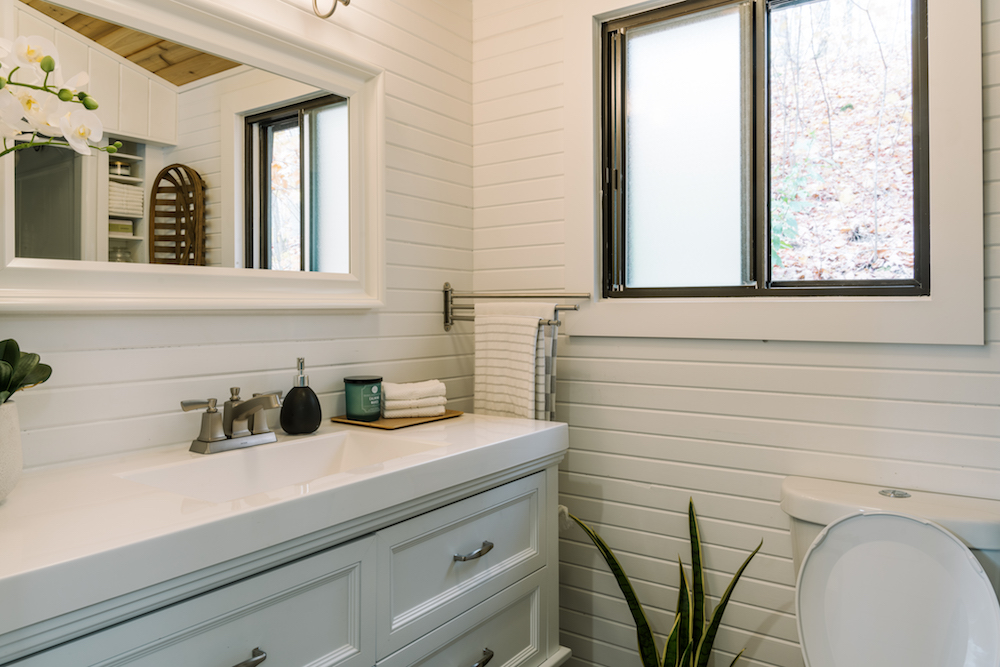 white bathroom with window and mirror