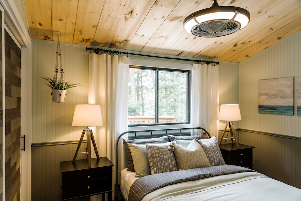 cottage bedroom with shiplap on walls and wood closet door