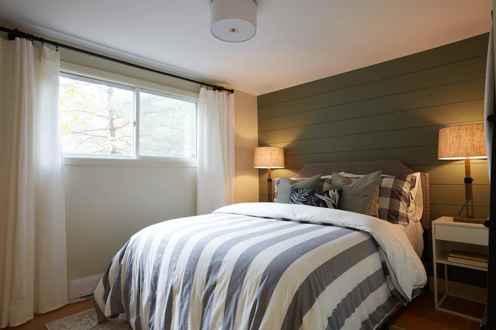 green and white bedroom with shiplap feature wall