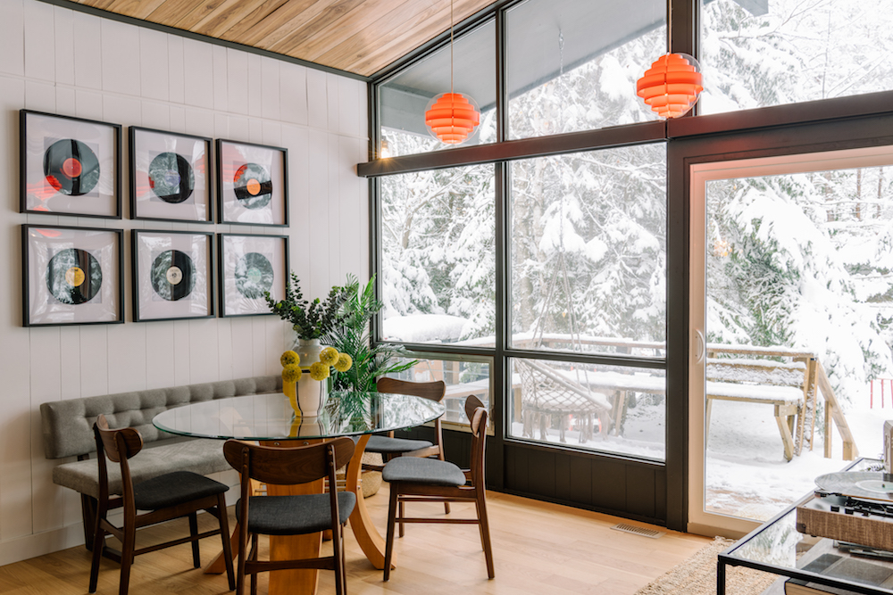 bright dining area with framed records on wall
