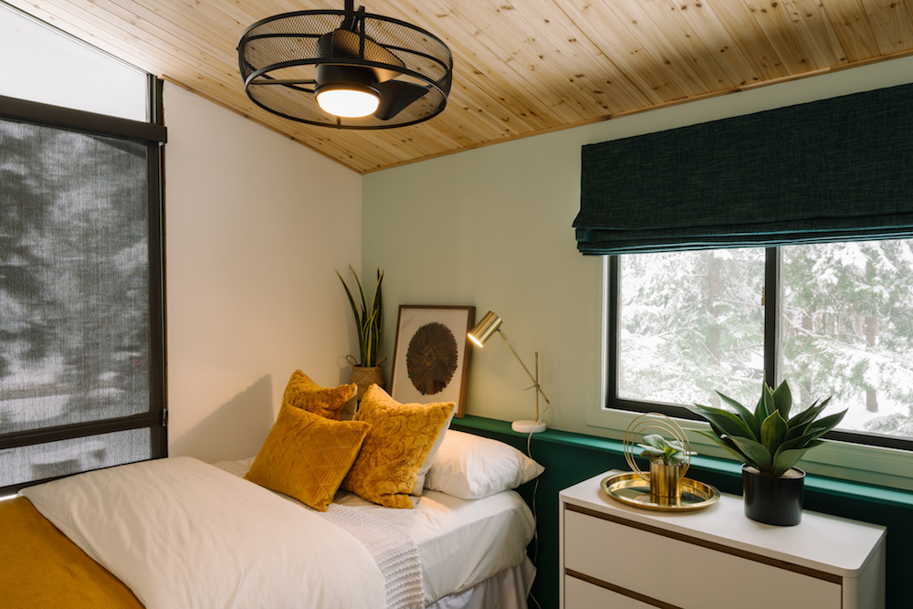 green bedroom with wood ceiling