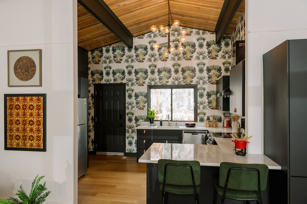 sleek green kitchen with wallpaper feature wall