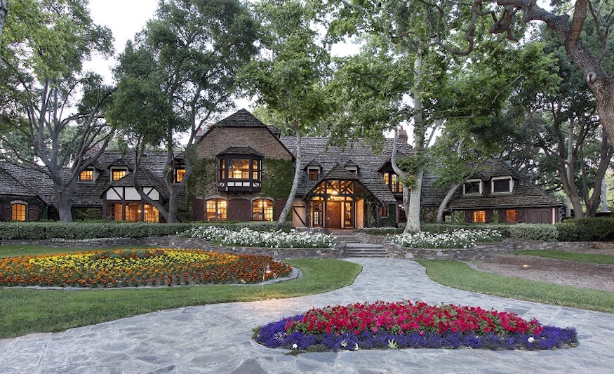 French-Normandy style main house on Neverland Ranch, surrounded by trees and flower beds
