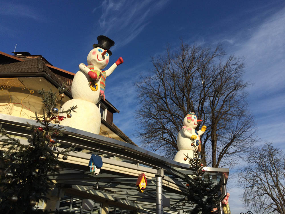 Snowman decorations on roof of house