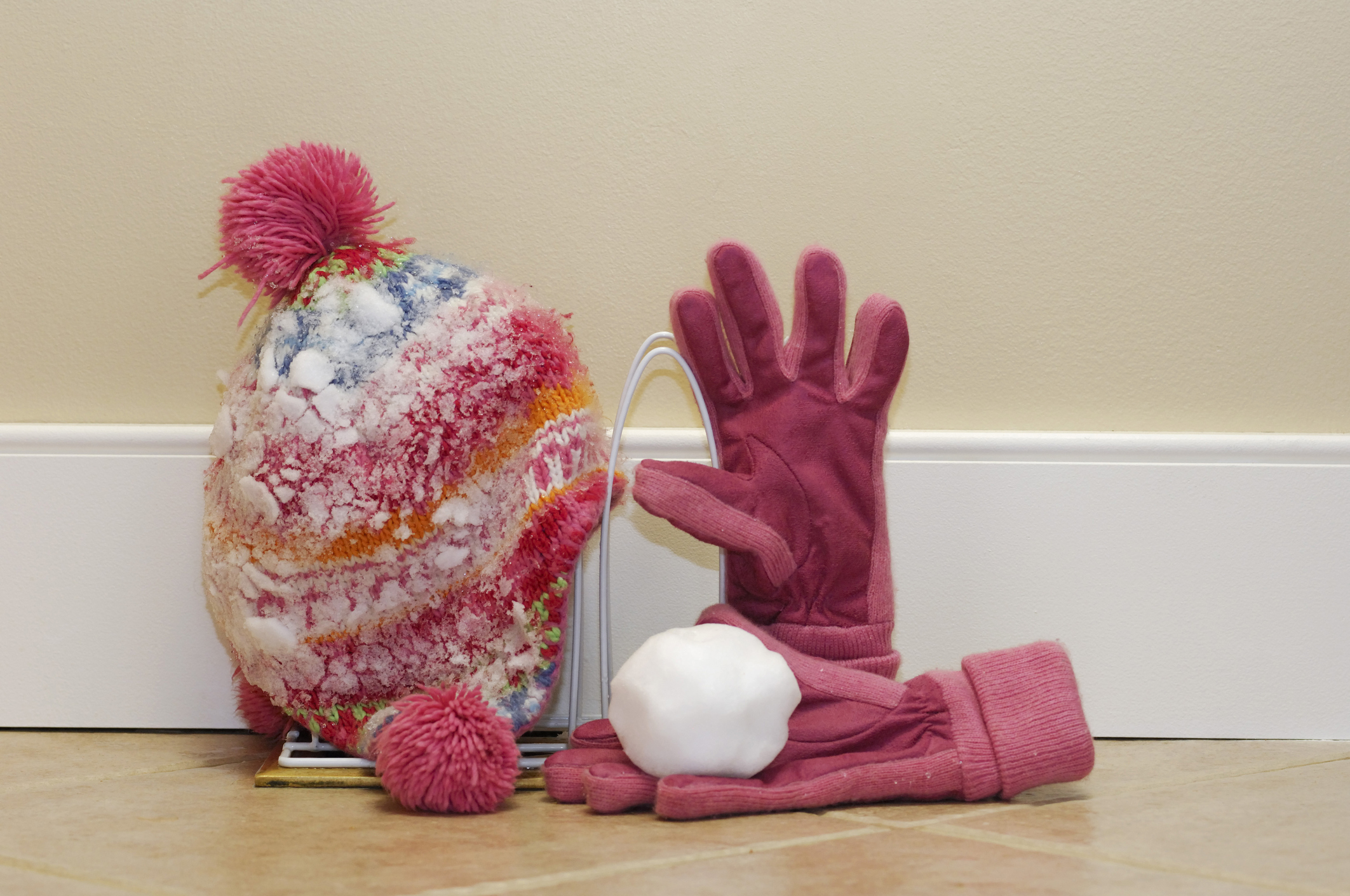 Winter hat and gloves warming on heating vent