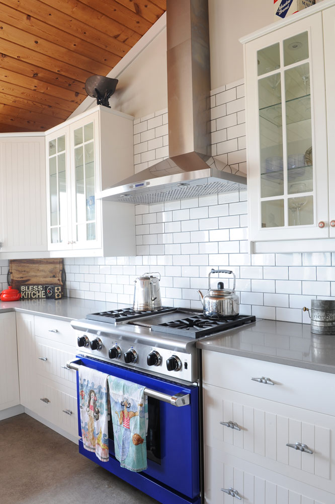 cottage kitchen with white subway tiles and blue oven