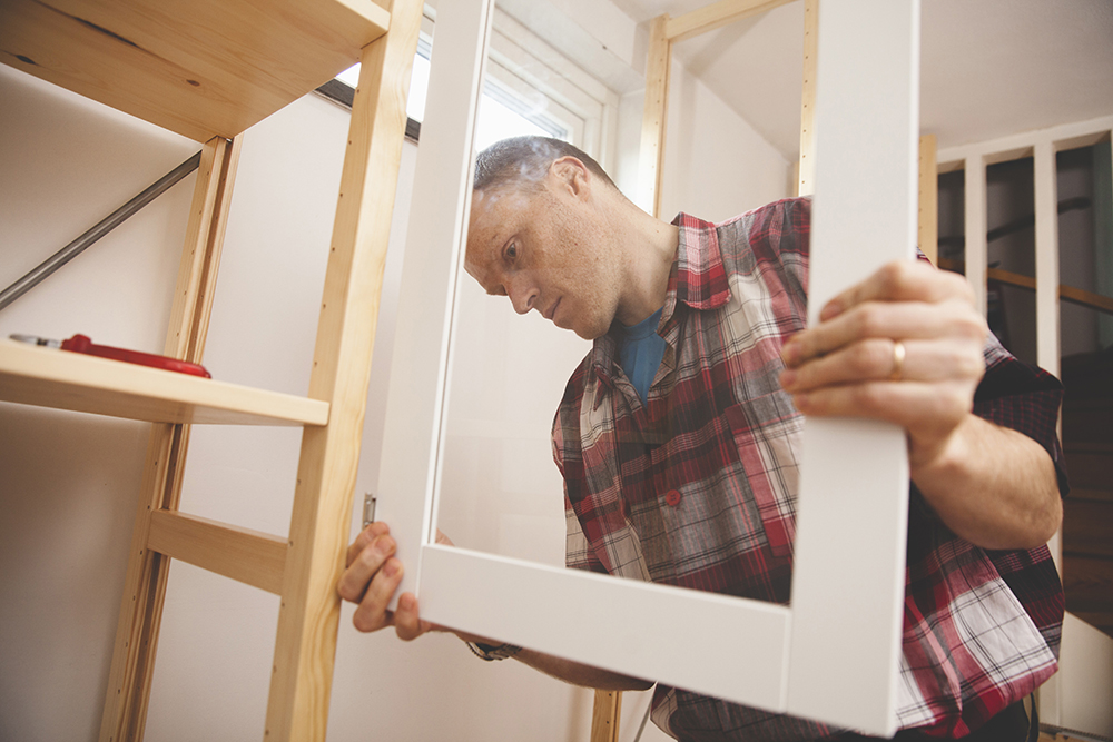 Man installing cabinet door