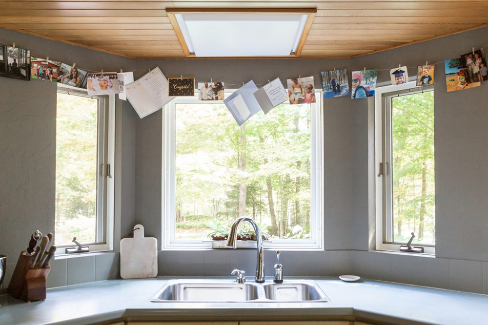 Kitchen sink overlooking windows and greenery