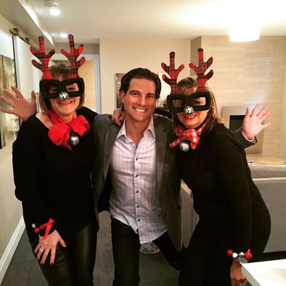 Scott McGillivray with coworkers in reindeer masks
