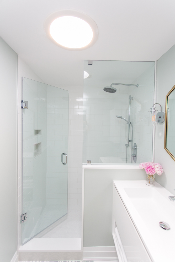 Master ensuite with glass-enclosed shower and a sun tunnel.