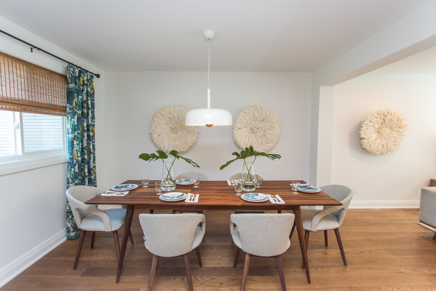 Modern dining space with wood table and mid-century modern chairs.