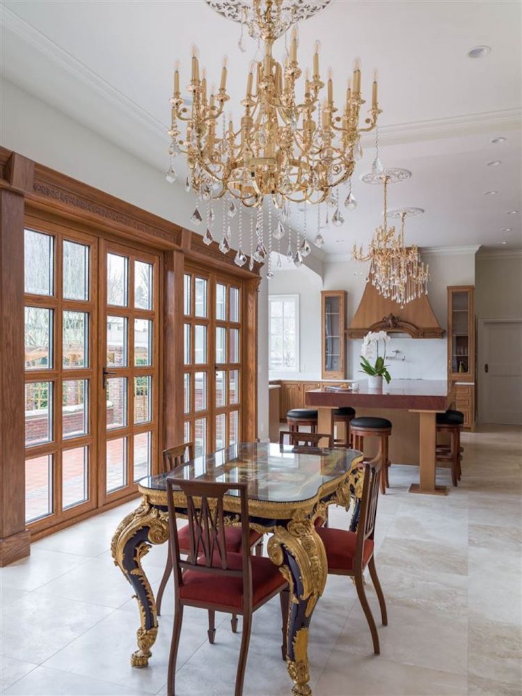 ornate kitchen with dining table and chandeliers