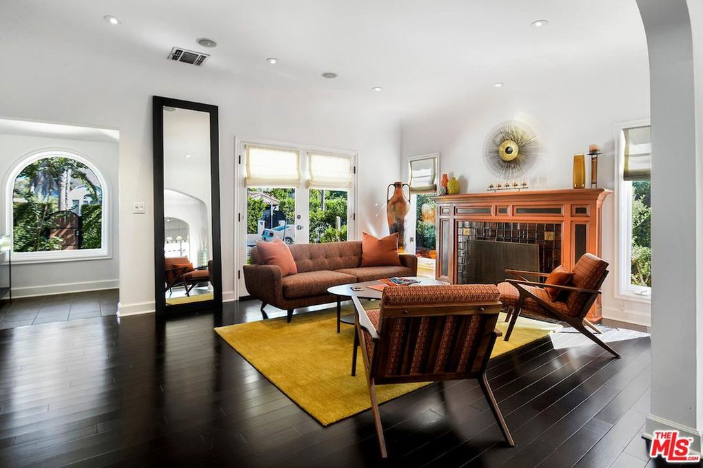 Seth Rogen living room with yellow area rug