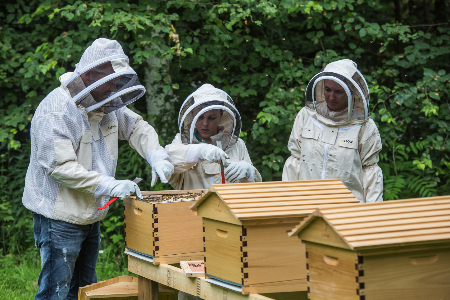 The Baeumler family tending to bee hives