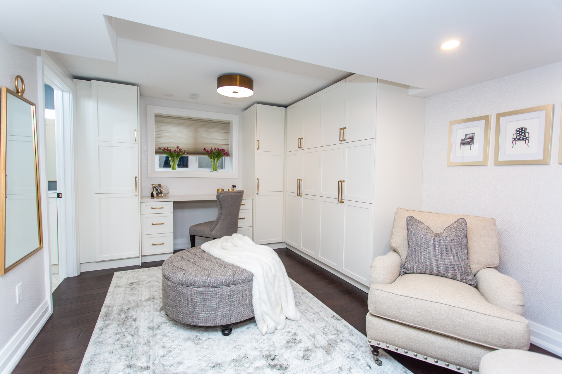 Basement suite dressing room with custom white built in cupboards