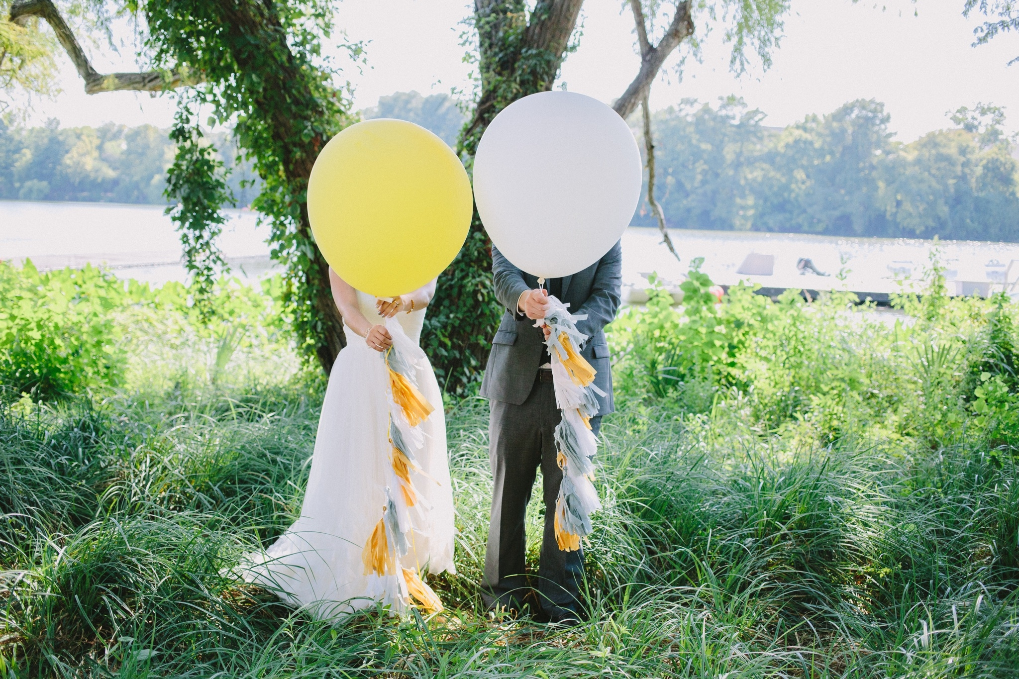 Couple standing behind balloons