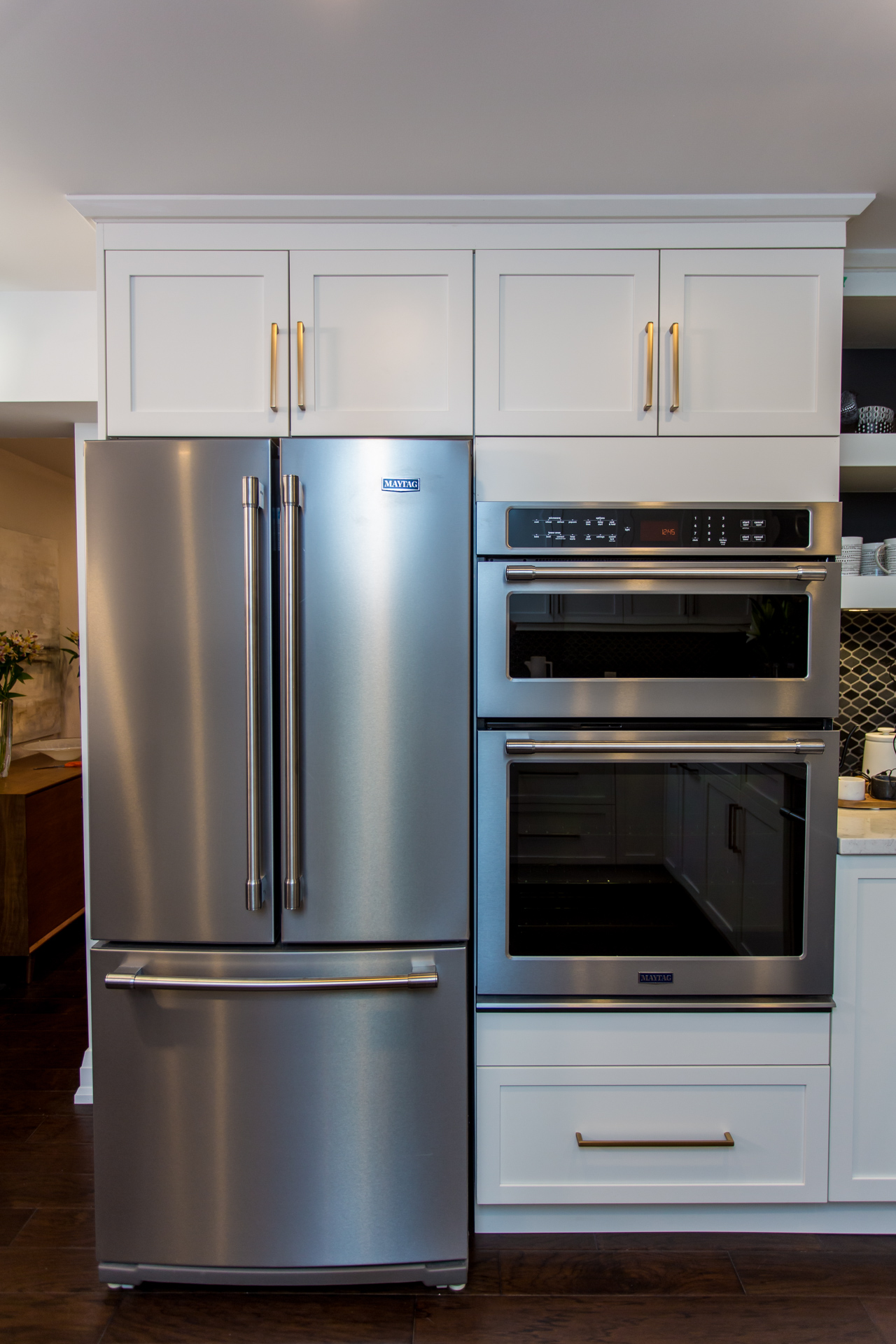 Chrome fridge and white cabinetry in the kitchen