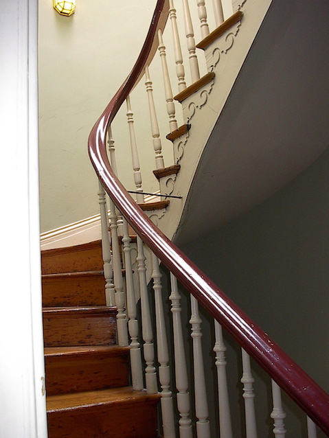 wooden staircase with railing