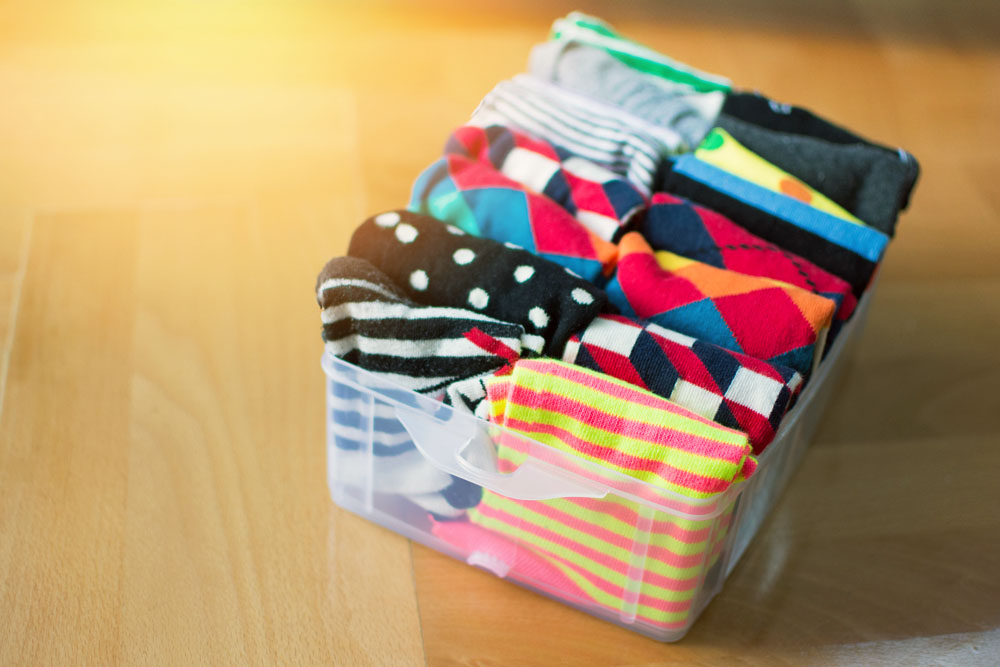 Basket with neatly folded colorful socks. Socks or clothes organization and sorting
