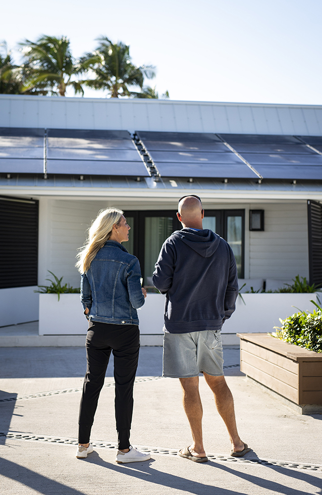 Sarah and Bryan Baeumler survey new solar panels installed on the roof of the resort.
