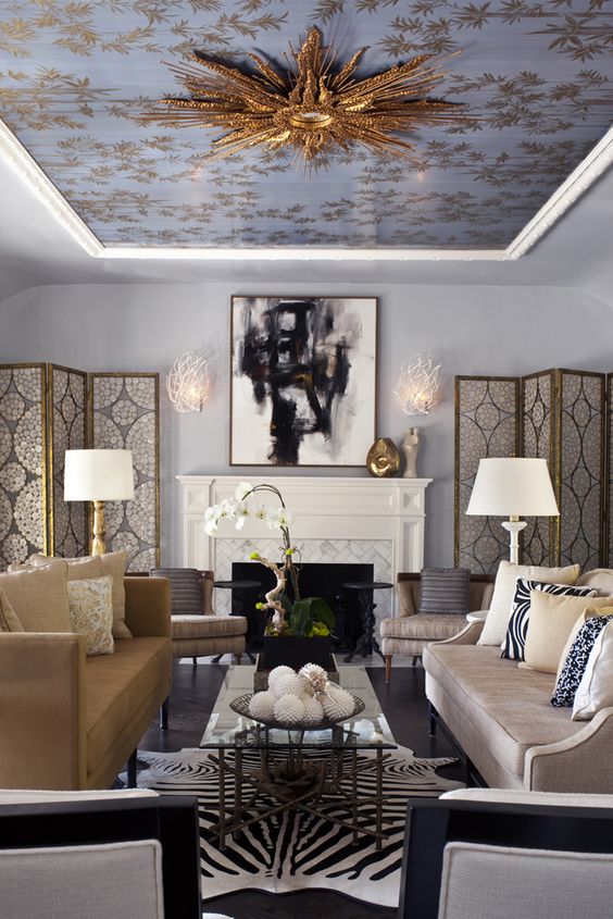 Glam living room with ornate gold ceiling
