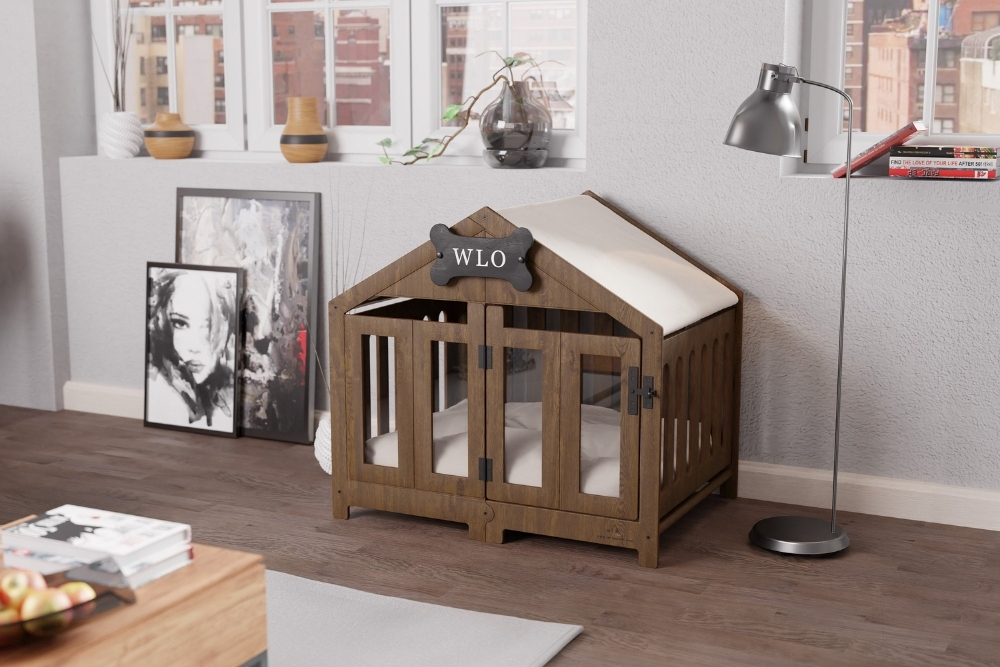A wooden dog crate shaped like a house with a black bone in the middle