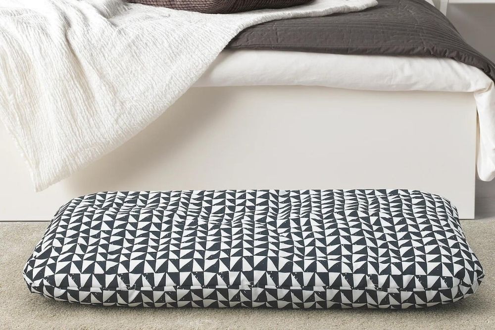 A black and white triangle dog bed cushion