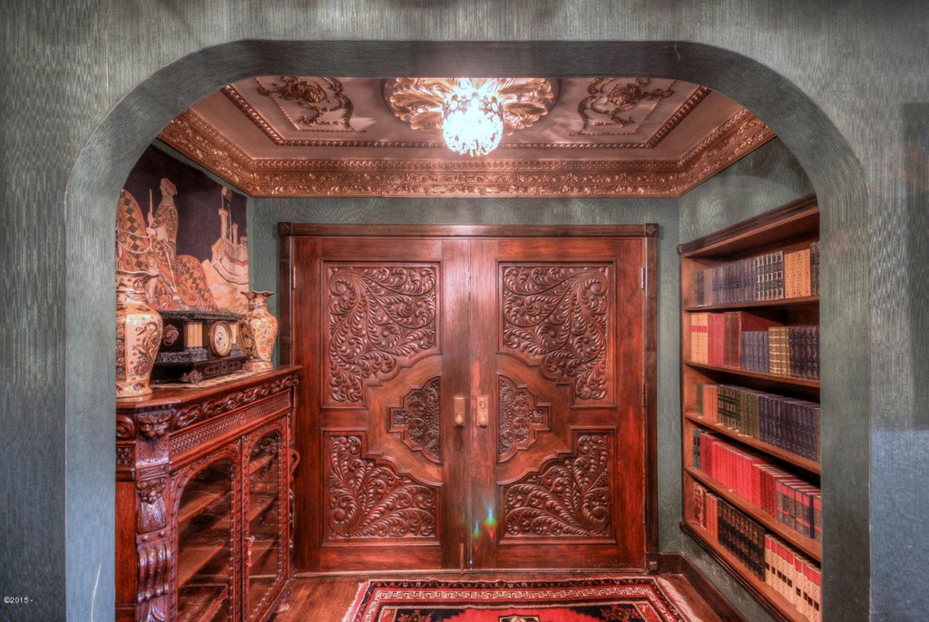 Thick hand-carved wooden doors and antique furnishings