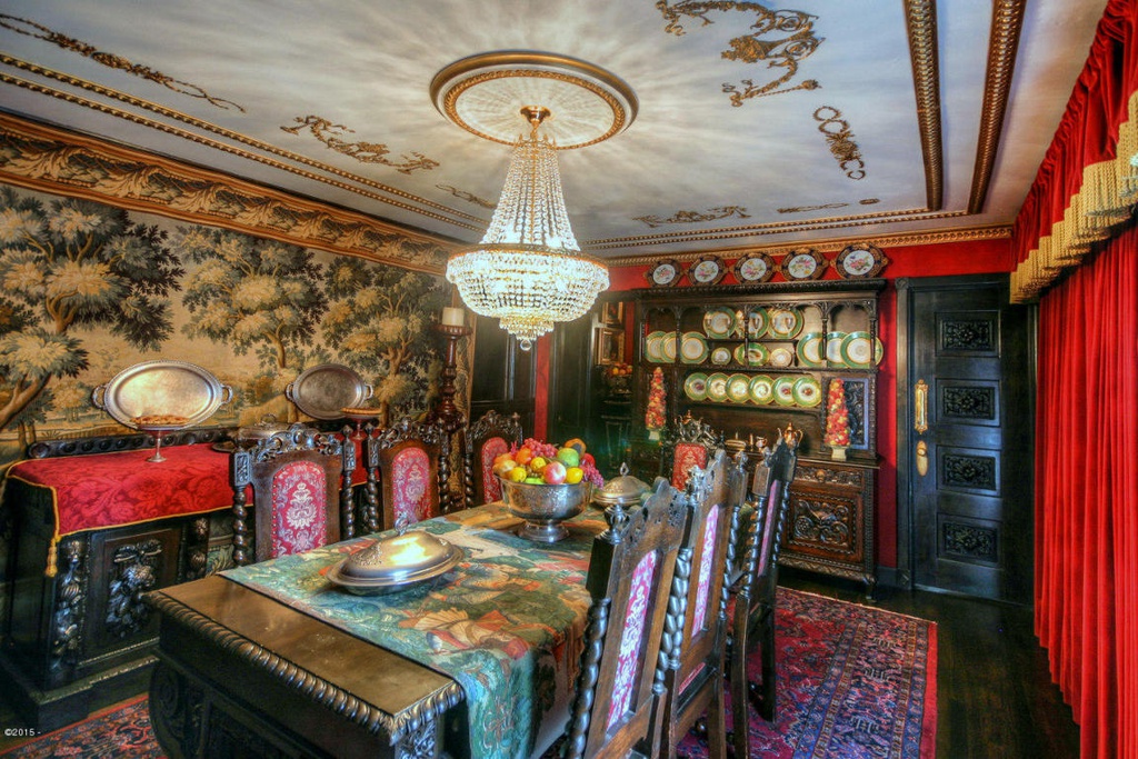 Grand dining room area with thick carpet, wallpapered walls and china cabinet